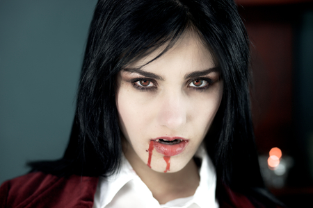 Scary vampire pale looking with red eyesの写真素材