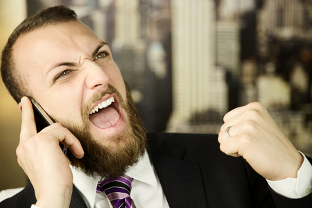 happy business man receiving great newsの写真素材