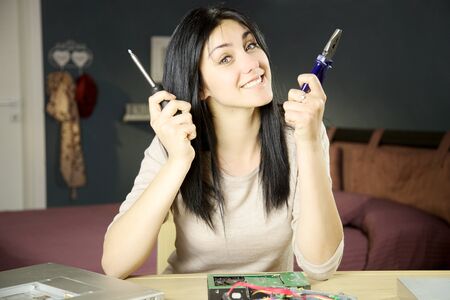 Happy woman taking care of broken technologyの写真素材