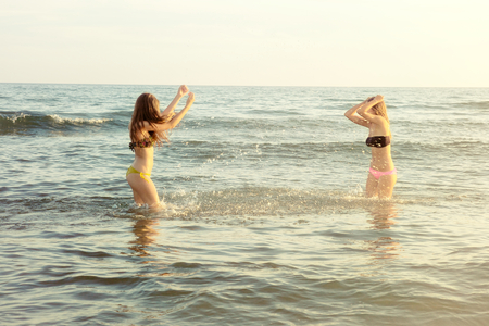 happy girls in summer in the seaの写真素材