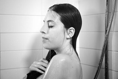 Gorgeous young woman taking showerの写真素材