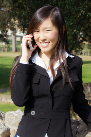 Cute young asian woman taking sun in springの写真素材
