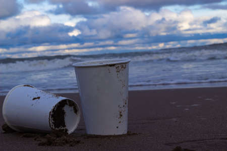 Two plastic cups in the sand.の写真素材