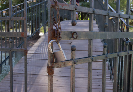 Old padlock on a metal door.の写真素材
