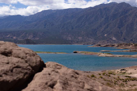 Beautiful scenery with a lake and mountains on a cloudy day.の写真素材