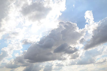 White clouds cumulus floating on blue sky with sunlights on backgroundの写真素材
