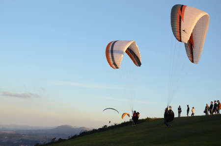 Two Paraglidings rising at sun set in Topo do Mundo (translated to Top of the World) in Minas Geraisのeditorial素材