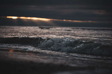 Close up of a wave in the sunset.の写真素材