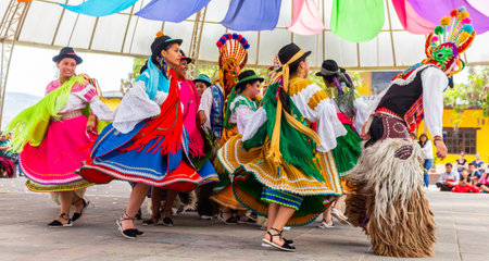 Women, women in typical costumes of South American Indians dancing with colorful traditional...