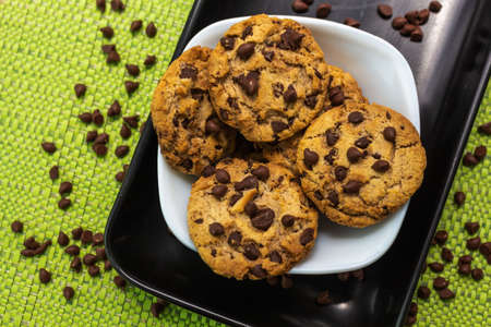 Cookies with chocolate chips sprinkled spontaneously on the table
