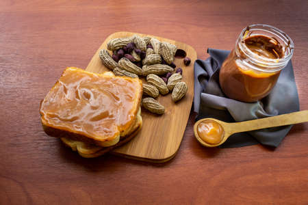 Peanuts with bread and peanut butter in a jar
