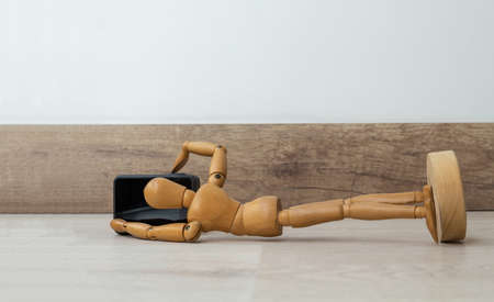 Wooden dummy with a photo camera and video lying on the floorの写真素材