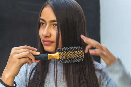 Close-up of a girl who is combing her hairの写真素材