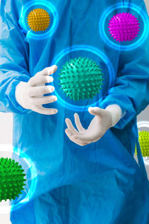 Doctor in a protective suit with various virus  molecules of various colors surrounding him as he...