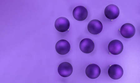 Purple background of Christmas balls with copy space. Ornament for December festivities