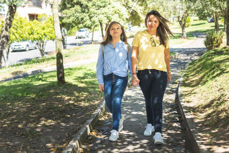Mother and daughter smiling on the way to school. Back to schoolの写真素材