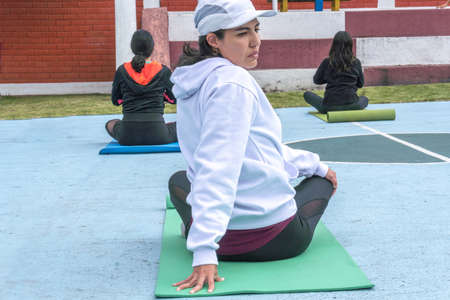 Group of women in a yoga class outdoors