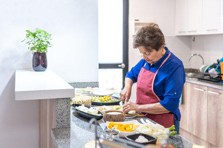 Old woman cooking in the kitchen