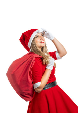 Young Latina Mama Noel with bag of gifts looks into the distance at Christmasの写真素材