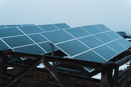 Rows of solar panels capturing sunlight in a snowy mountain environment, generating clean and...