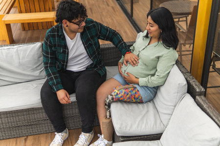 Loving couple with a pregnant woman and a man touching her belly, showing inclusion
