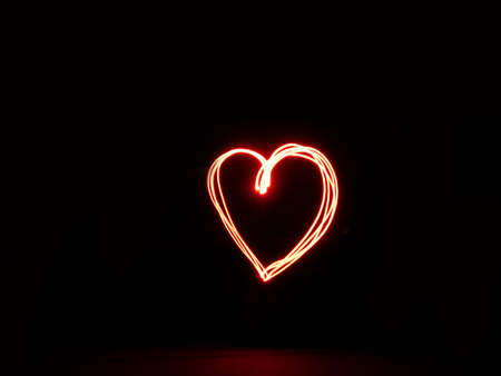 Long exposure heart red colour outline outside sign light paintingの写真素材