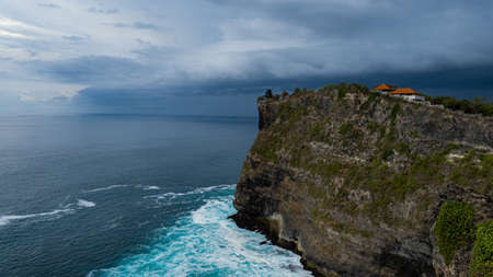 Uluwatu Temple cliff view at the coastline on Bali Indonesia before heavy rainの写真素材