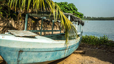 A blue wooden boat in African paradise, Beninの写真素材