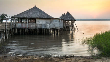 Sunset with Stilt house on Aheme lake in Benin, West Africaの写真素材