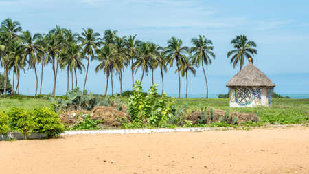 Small hute with palm trees on the africa coast, Ouidah in Benin