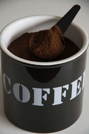 ground coffee, box and spoon. Coffee is written on the boxの写真素材