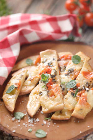 Over baked gourmet flatbread with roasted tomatoesの写真素材