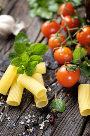Raw rigatoni pasta with herbsの写真素材