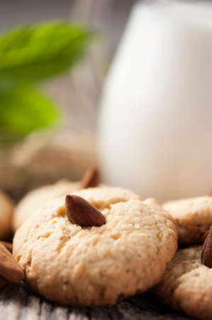 Almond biscuits and a jar of milkの写真素材
