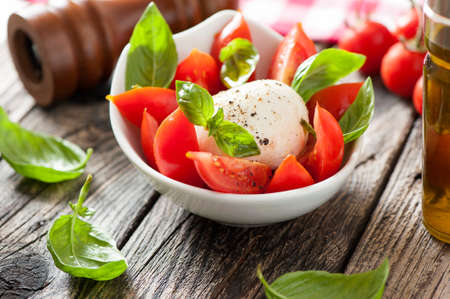 fresh caprese salad in bowlの写真素材