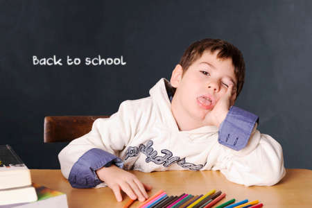 Little boy sitting at the table. School conceptの写真素材