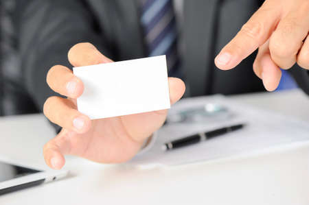 Businessman showing his business cardの写真素材