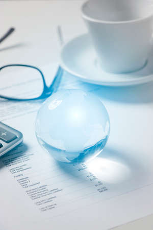 Glass globe  and business papersの写真素材