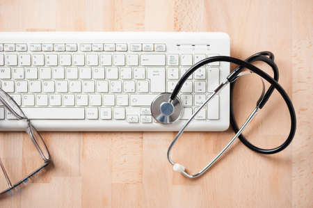 stethoscope and a computer keyboardの写真素材