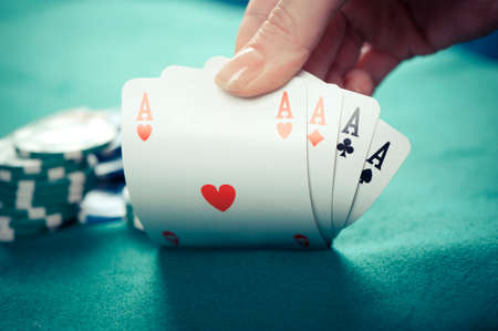 A poker hand of four aces with chips