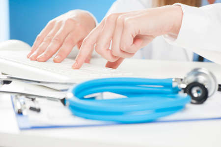 doctor typing on the keyboard