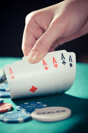 A poker hand of four aces with chips