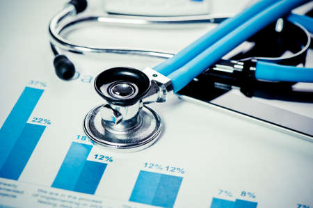 Stethoscope and financial chartsの写真素材