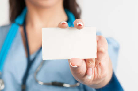 Female doctor holding blank business card with copy spaceの写真素材