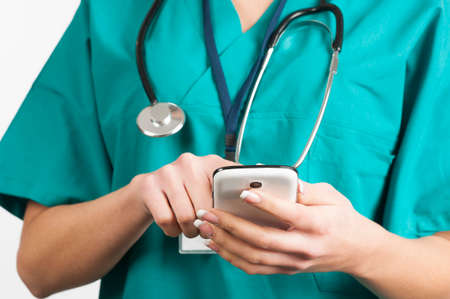 Doctor hands texting on a smart phone