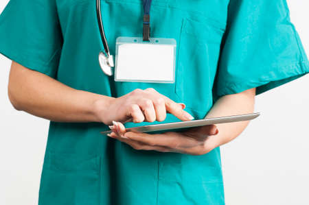woman doctor hand touching a tablet