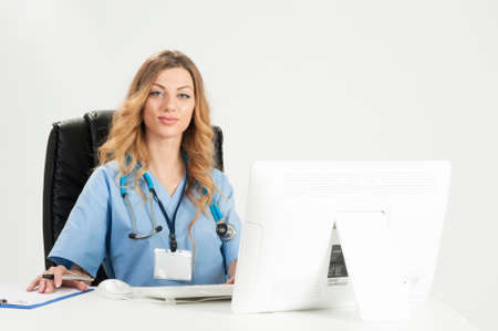 Attractive female doctor sitting on her deskの写真素材