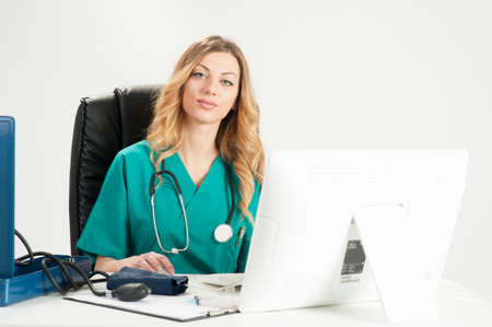 Attractive female doctor sitting on her deskの写真素材