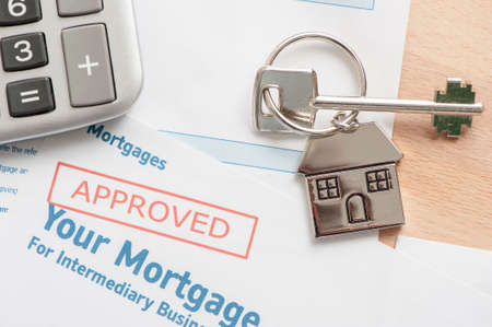 Approved Mortgage loan application with house keyの写真素材