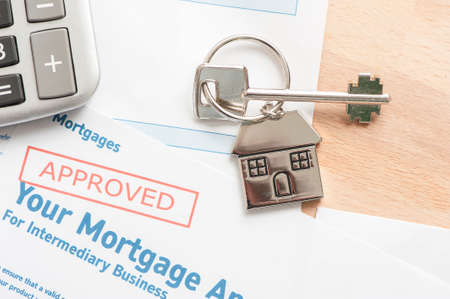 Approved Mortgage loan application with house keyの写真素材